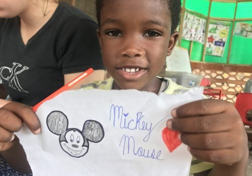 Student-showing-her-finished-drawing-of-Mickey-Mouse-scaled